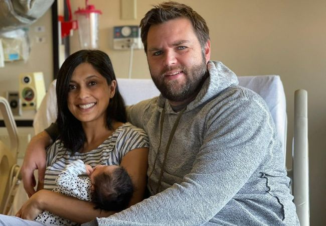 A picture of Usha Vance and her husband, J. D. Vance with their youngest daughter.